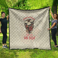 Cream quilt with diamond stitching and skull graphic with red text