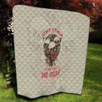 Cream quilt with rounded corners, skull artwork and red lettering, diamond quilt