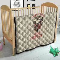 Cream nursery quilt with skull graphic and red text, diamond stitching and black border