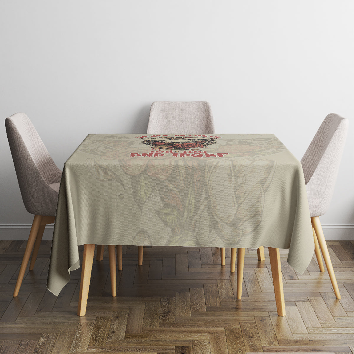 Square tablecloth in light beige with multicolor skull text across the center