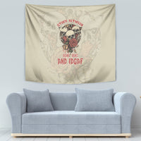 Beige tapestry showing a skull with red roses and red statement text