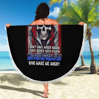 Round black beach blanket held open, featuring skull and stars-and-stripes graphic with fringe