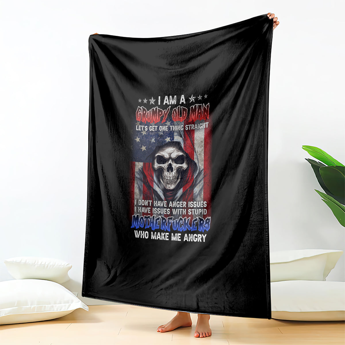 Black throw blanket featuring a skull graphic with red, white, and blue text design