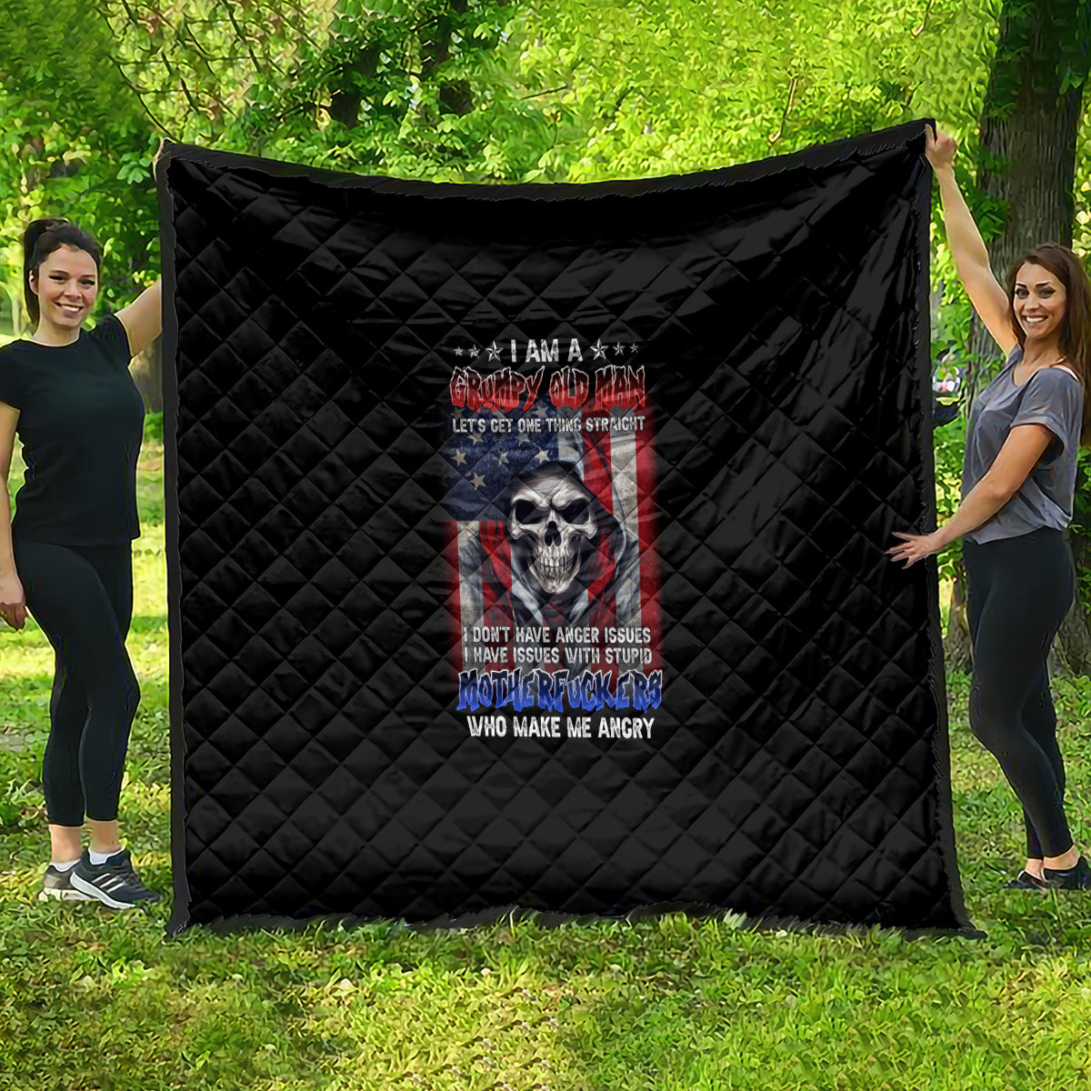 Black quilt with diamond stitching and colorful skull graphic centered on the throw