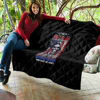 Black quilt spread across a couch with diamond stitching and centered skull graphic