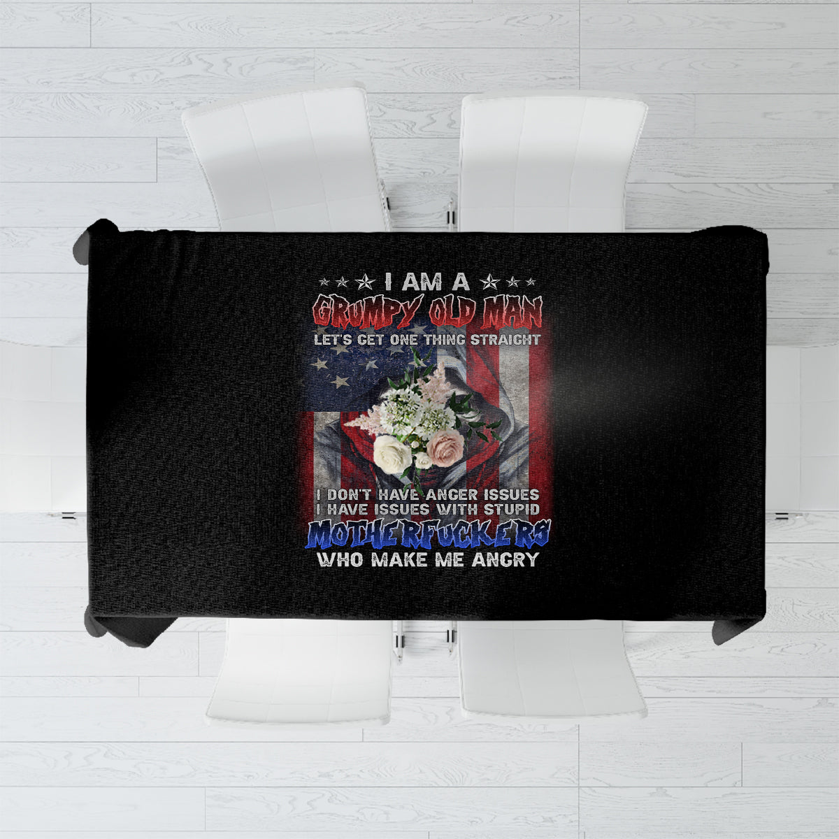 Black tablecloth with centered humorous print featuring bold text and floral graphic