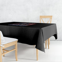 Black tablecloth draped over a square table, corner drop and folded edge visible