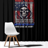 Black window curtain with multicolor skull and motto graphic, dark full-length panel.