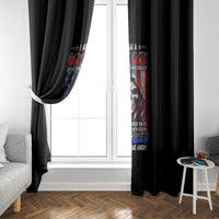 Black window curtain with vertical skull and multicolor text graphic, side view near window.