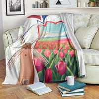 Multicolor Dutch windmill and tulip print blanket with white border on couch