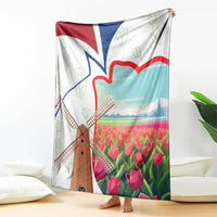 Hanging multicolor Dutch windmill and tulip blanket with red and blue flag accents