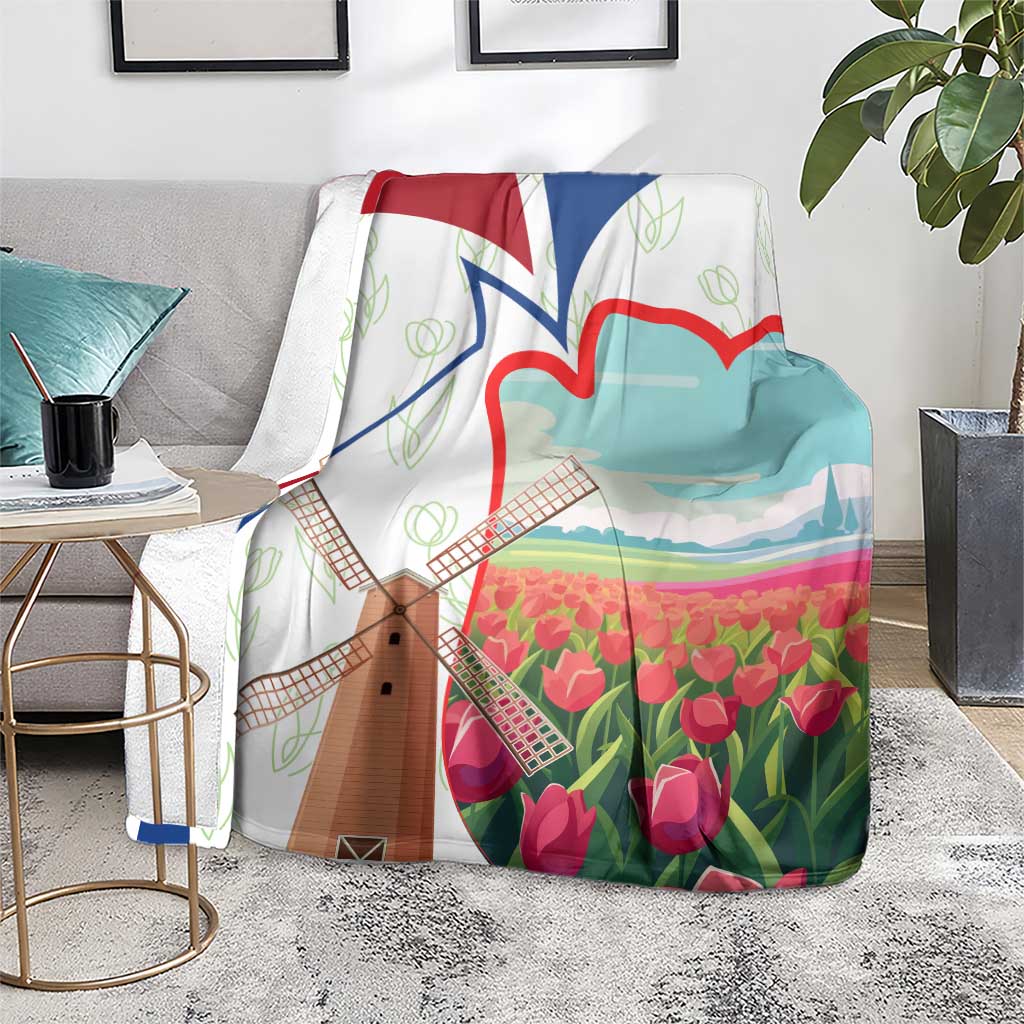 Multicolor Dutch windmill and tulip blanket on gray rug beside side tables