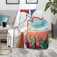 Multicolor Dutch windmill and tulip blanket on gray rug beside side tables