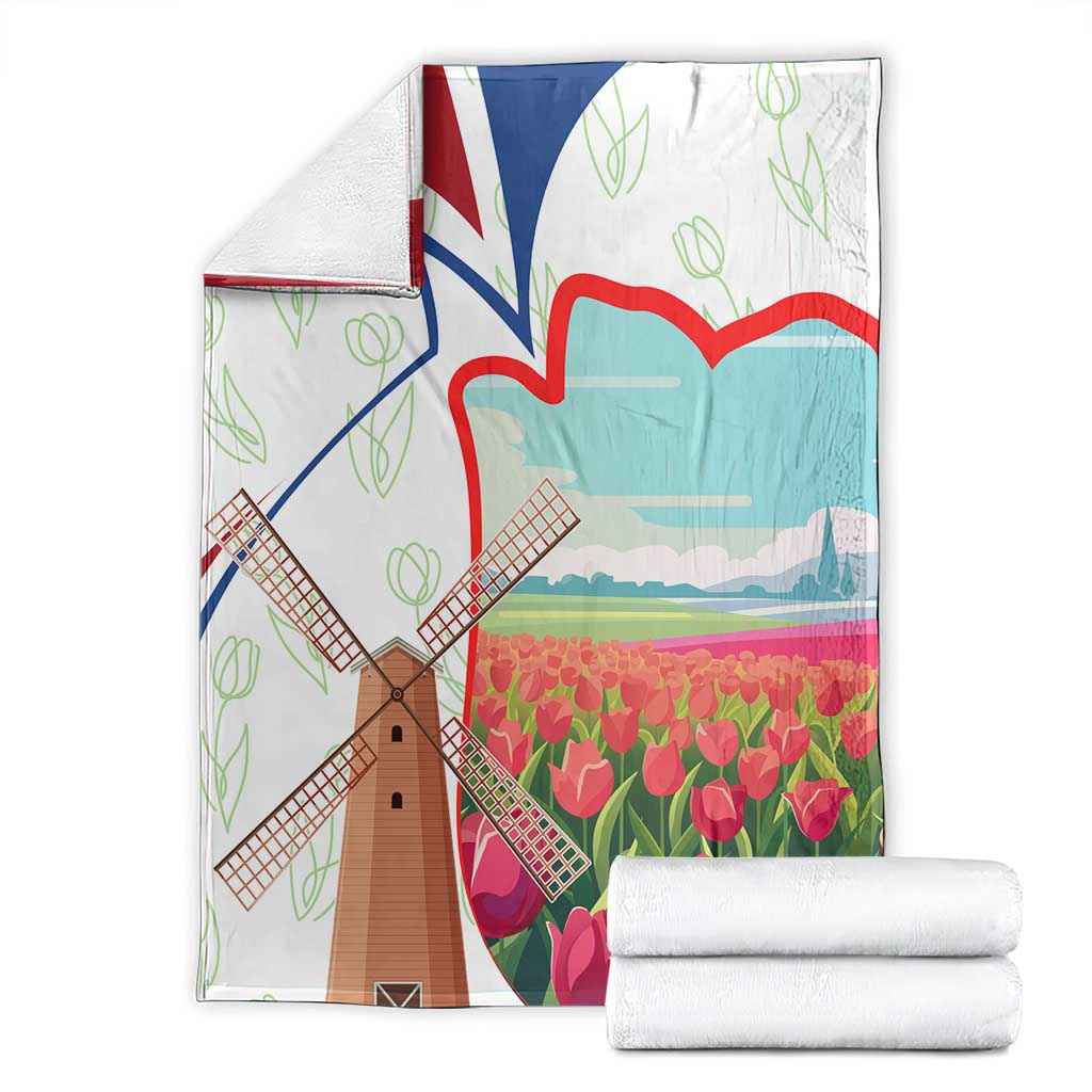 Folded multicolor Dutch windmill and tulip print blanket in a white border