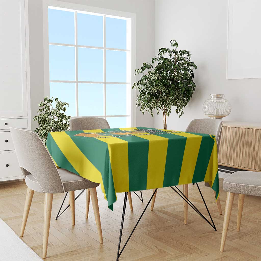 Green and yellow striped tablecloth with palm trees and ocean scene