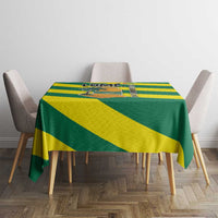 Green and yellow striped tablecloth featuring palm tree ocean embrace design