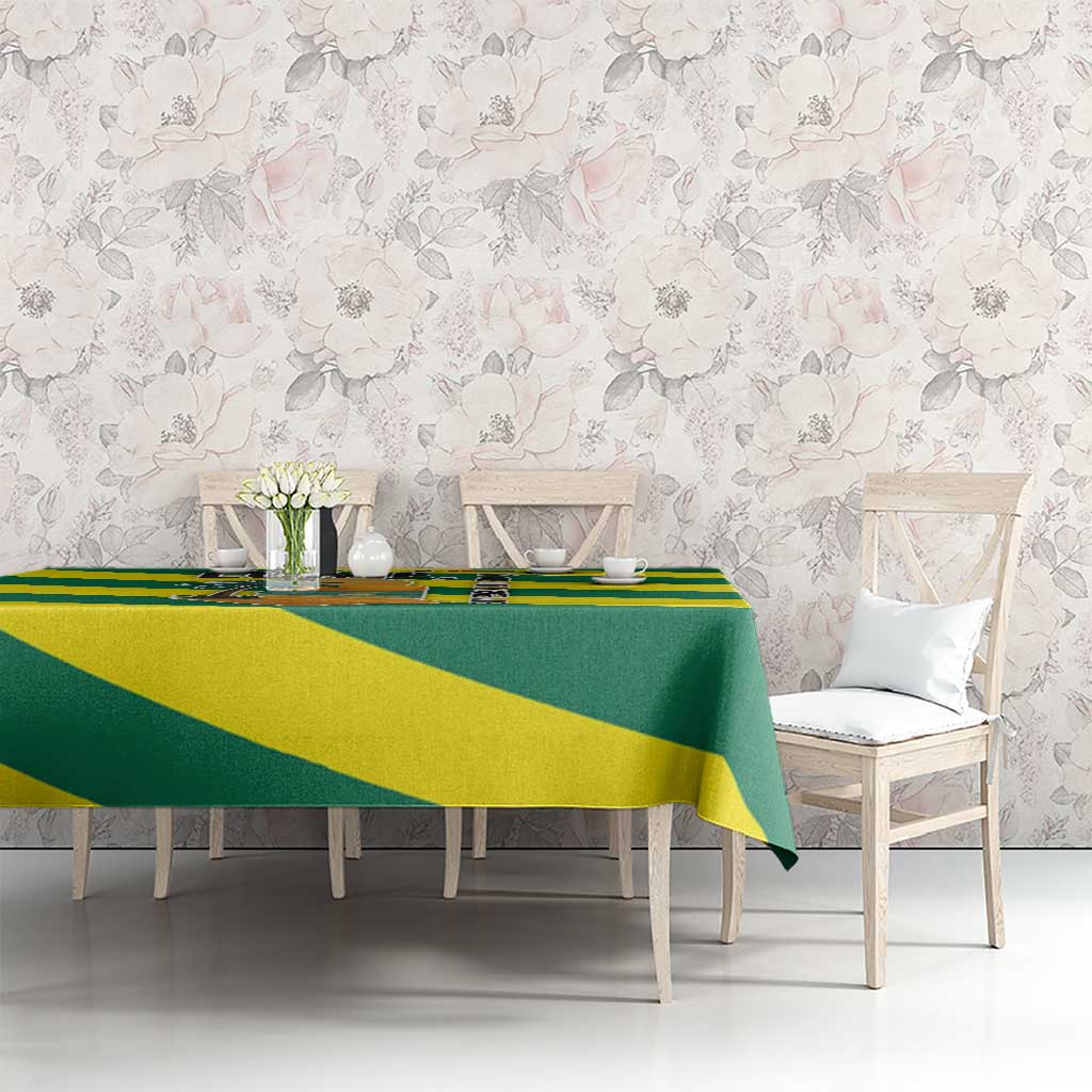 Green and yellow striped tablecloth with palm tree and ocean sunset graphic