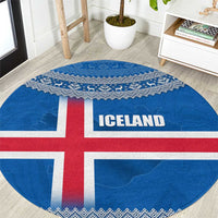 Round blue Iceland flag rug with red cross and ICE LAND lettering, Nordic knit edge