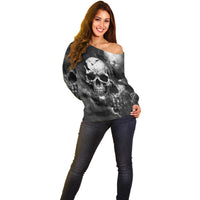 Black off-shoulder sweater with skull graphic and smoky grunge pattern