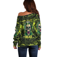 Women’s off-shoulder sweater, back features green multicolor skull and text print.