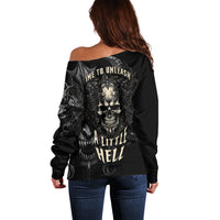 Women's black off-shoulder sweater with large skull graphic and text on back