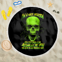 Round black beach blanket with neon green skull graphic, shown flat with white fringe