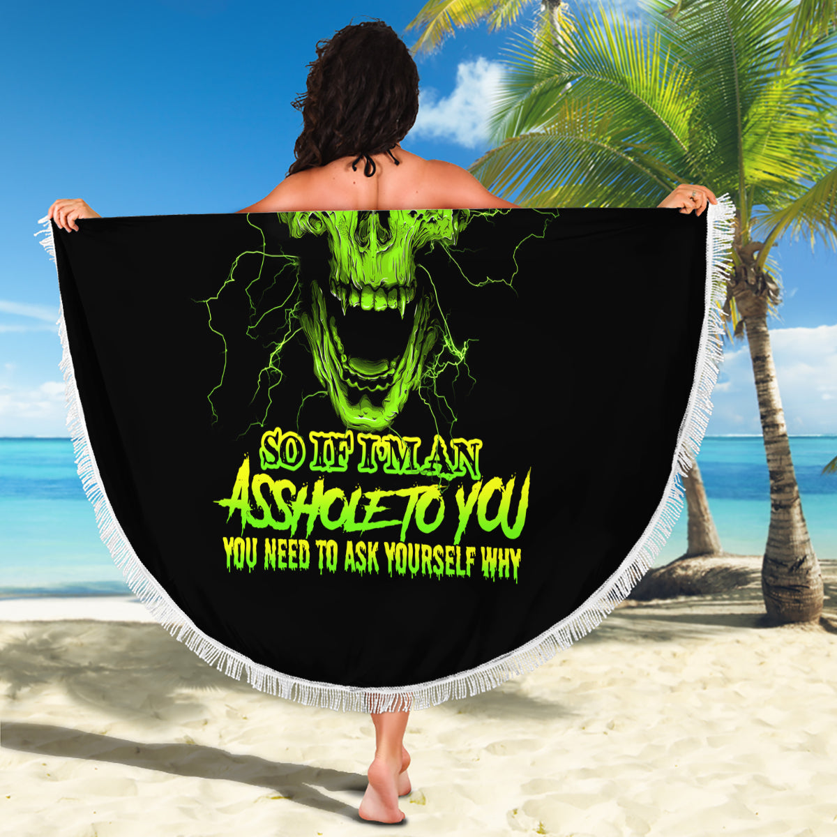 Round black beach blanket with neon green skull graphic and white fringe, held up
