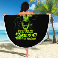 Round black beach blanket with neon green skull graphic and white fringe, held up