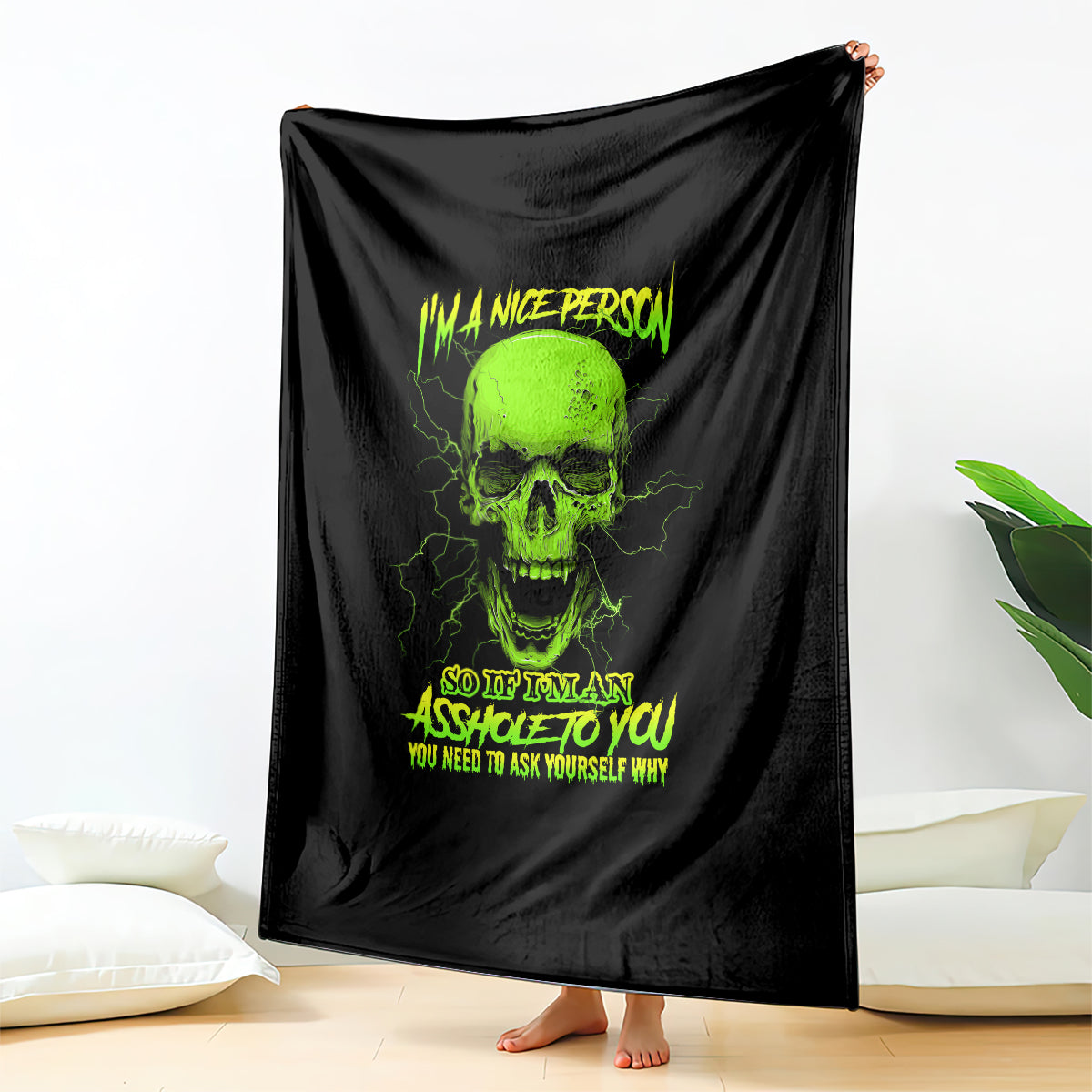 Neon skull blanket with black background and text, draped vertically