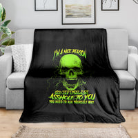 Skull blanket with neon green skull and text on black, draped over couch