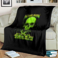 Black skull blanket with neon green skull graphic and slogan, over sofa