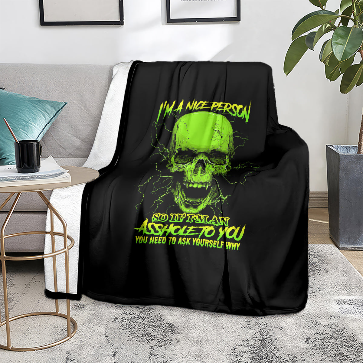 Skull blanket with neon green skull and text, draped over gray couch