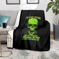 Skull blanket with neon green skull and text, draped over gray couch