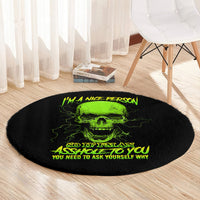 Round black carpet with neon green skull graphic and yellow quote text, close view