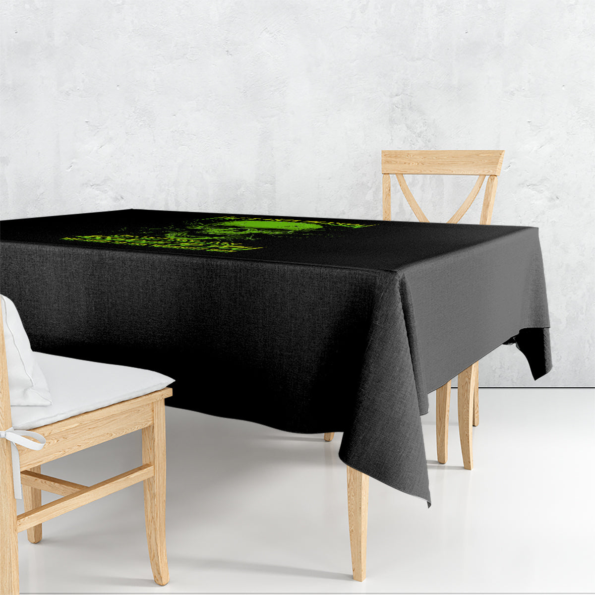 Black tablecloth with green skull graphic and text, draped over a table corner