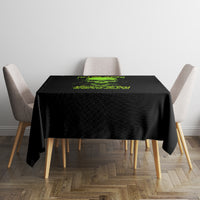 Black tablecloth with green skull banner design, centered on a square dining table