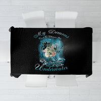 Black tablecloth with centered mermaid illustration and blue decorative text graphic
