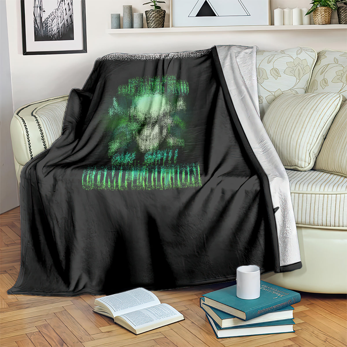 Black skull-themed throw blanket with neon-green text, draped over striped couch