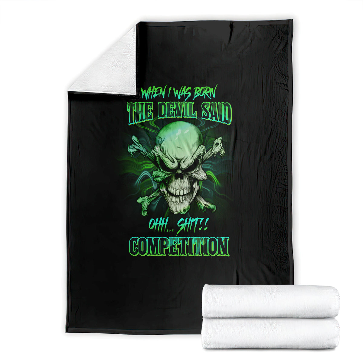 Black skull graphic throw blanket with neon-green text, stacked with rolled towels