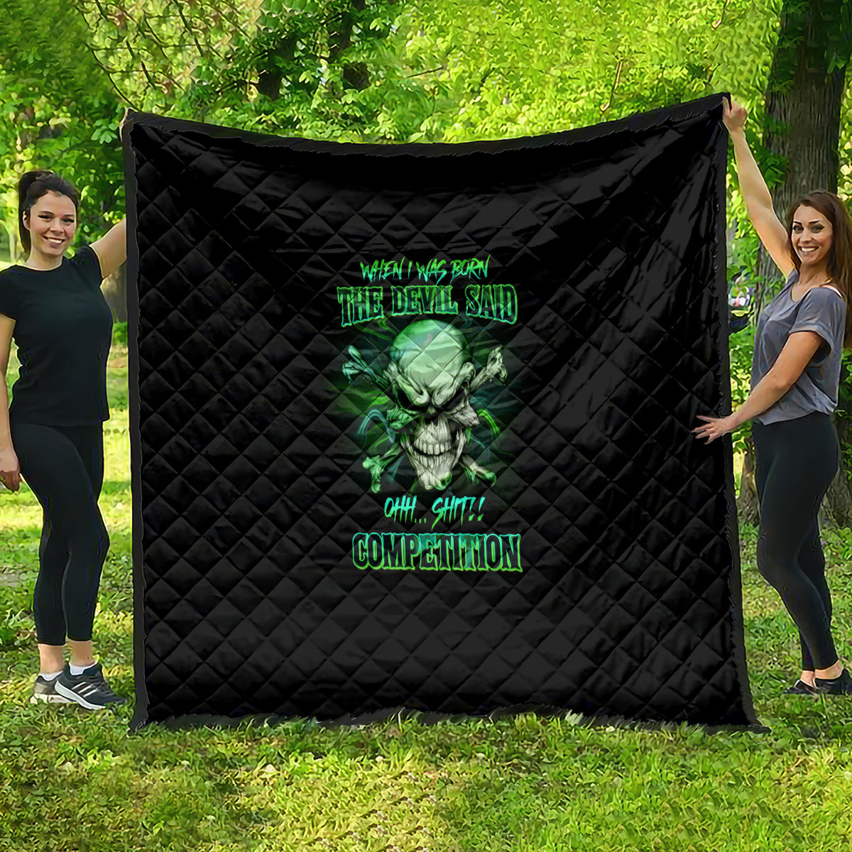 Black quilt with green skull graphic and neon text, diamond-quilted pattern.