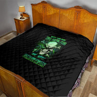 Black quilt on bedspread with green skull graphic and neon text, diamond quilting.
