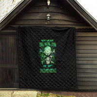 Black quilt blanket hanging indoors with green skull design and neon text, quilted.