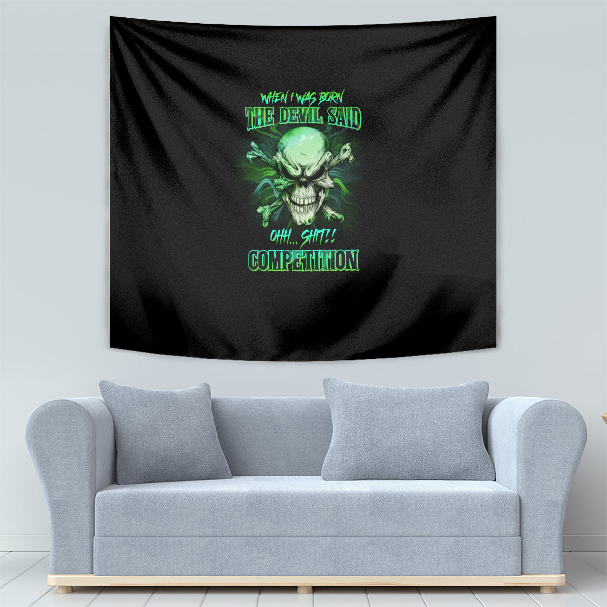 Black skull tapestry with green graphic, hung behind a light-gray sofa.