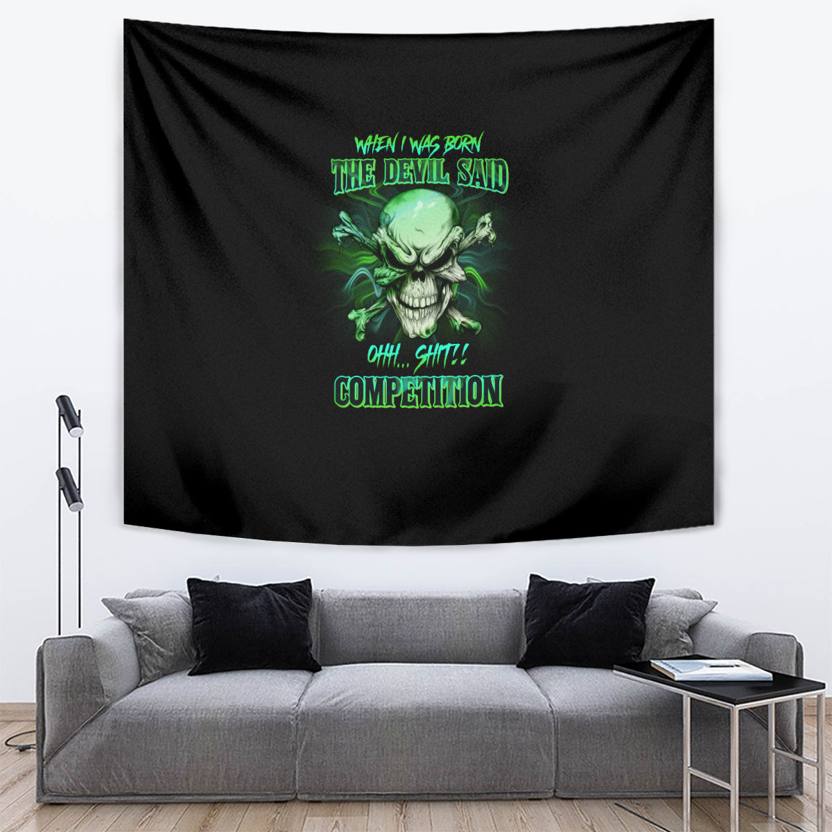 Black skull tapestry with green skull design and text, displayed above a gray couch.