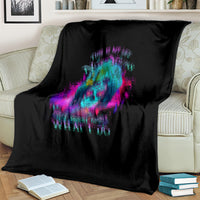 Black blanket with colorful skull graphic and quote text, draped over a light couch.
