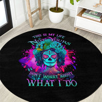 Round black carpet with multicolor sugar skull face and 'WHAT I DO' lettering
