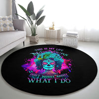Round black carpet with vibrant sugar skull floral design and 'WHAT I DO' slogan