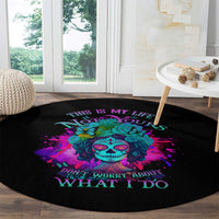 Round black carpet featuring turquoise sugar skull, purple-pink splatter, 'WHAT I DO'