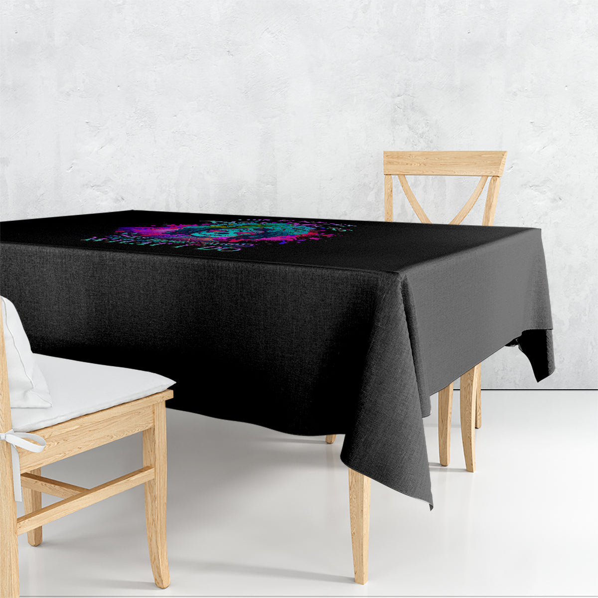 Black square tablecloth with multicolor abstract print across the top edge