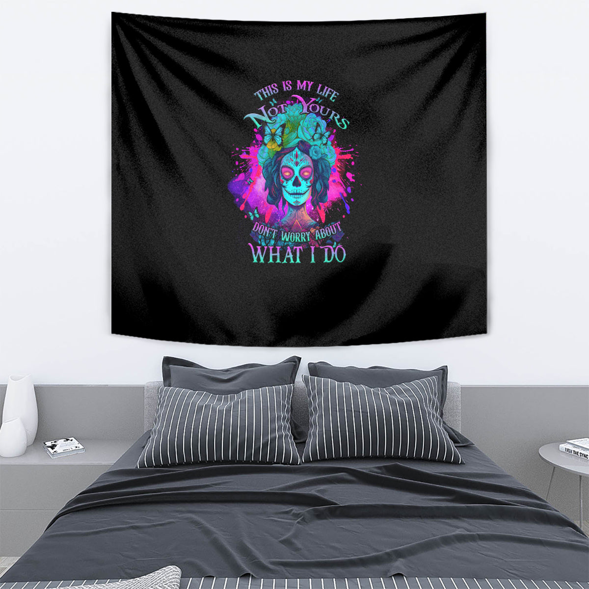 Black wall tapestry with colorful skull portrait and neon-style "what I do" text